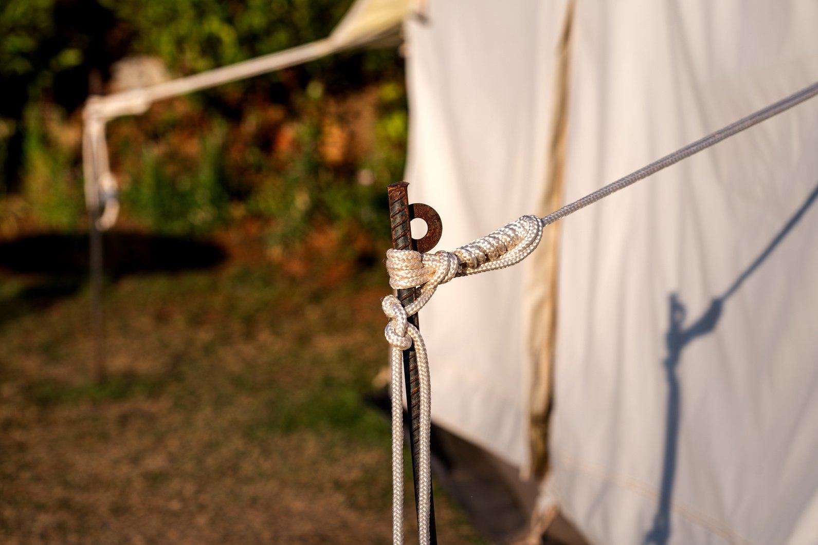 Tent camping anchor and rope knot.