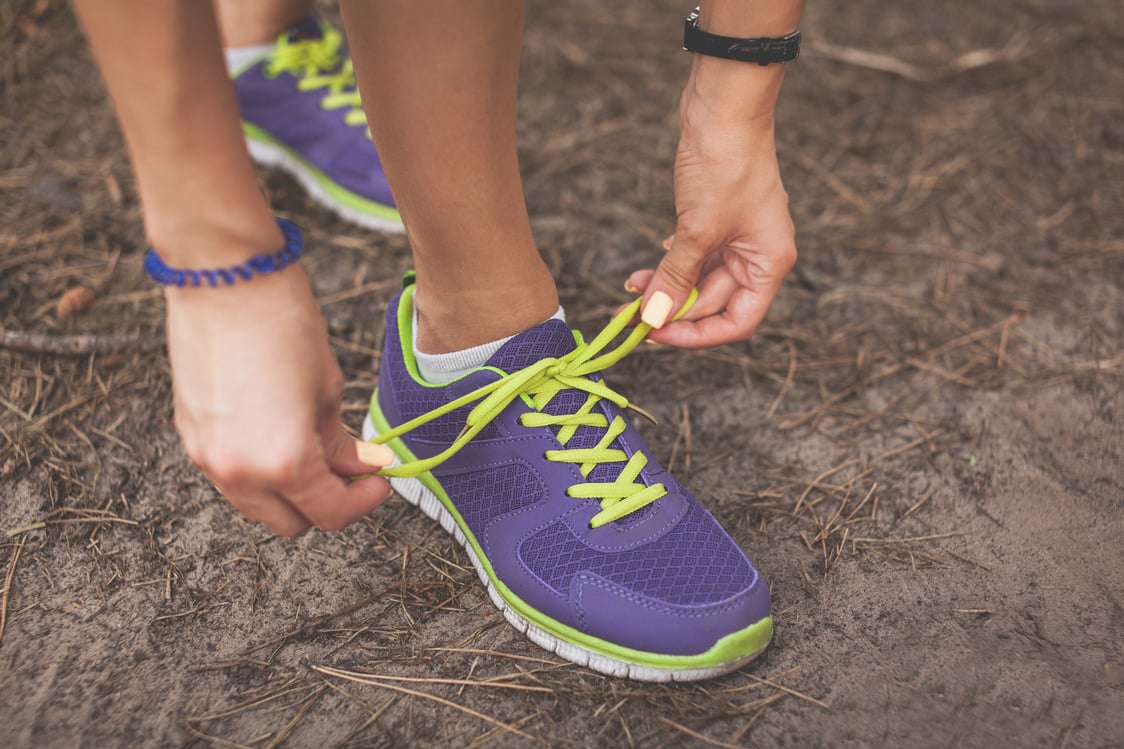 Runner woman tying shoelaces. Tie shoelaces